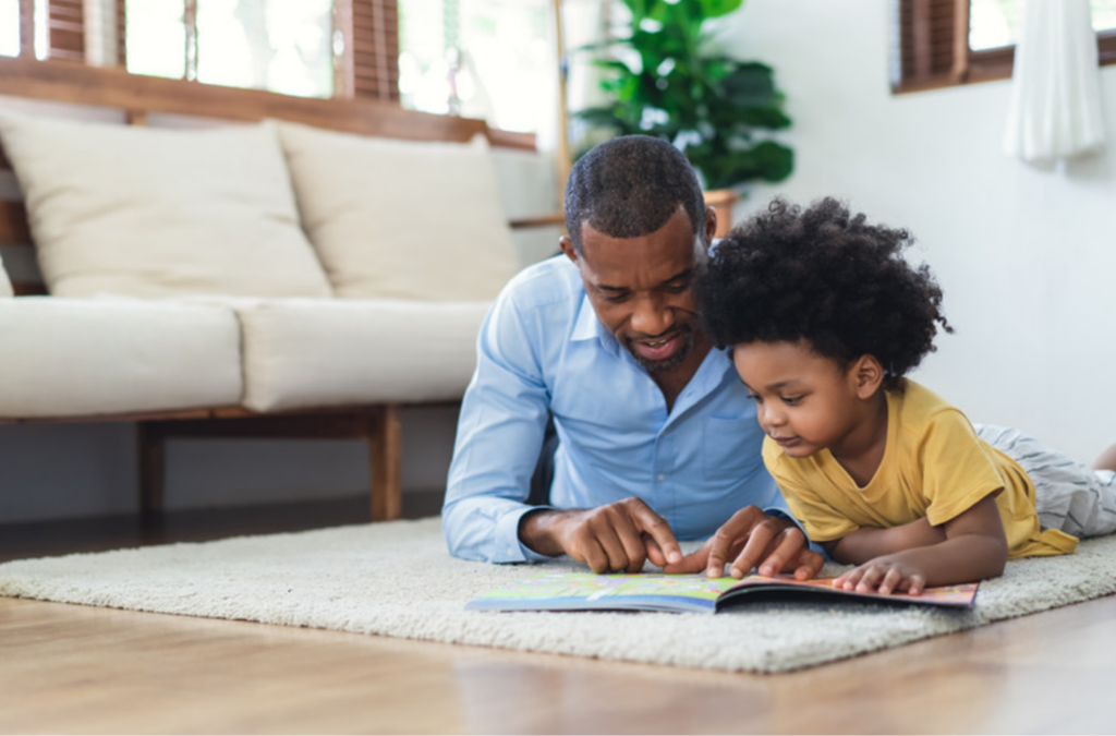 Parent and child spending time together reading a children's book.