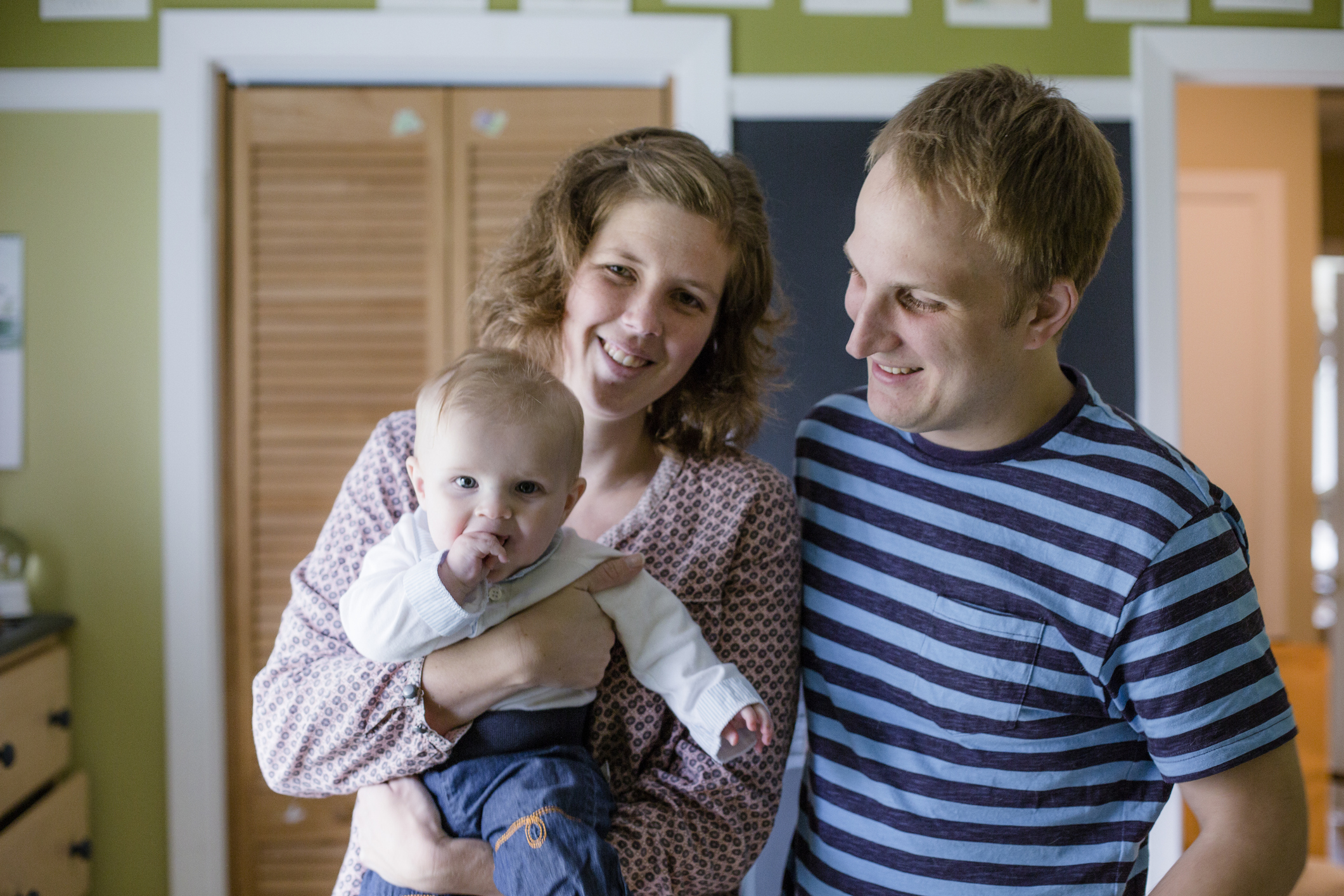 Parent couple holding their baby